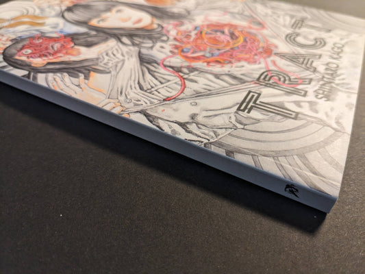 Spine and angled view of TRACT pocket edition, paperback binding.