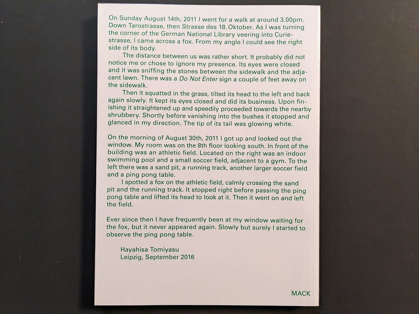 Back cover of TTP by Hayahisa Tomiyasu, showing text excerpt printed in green on white background.