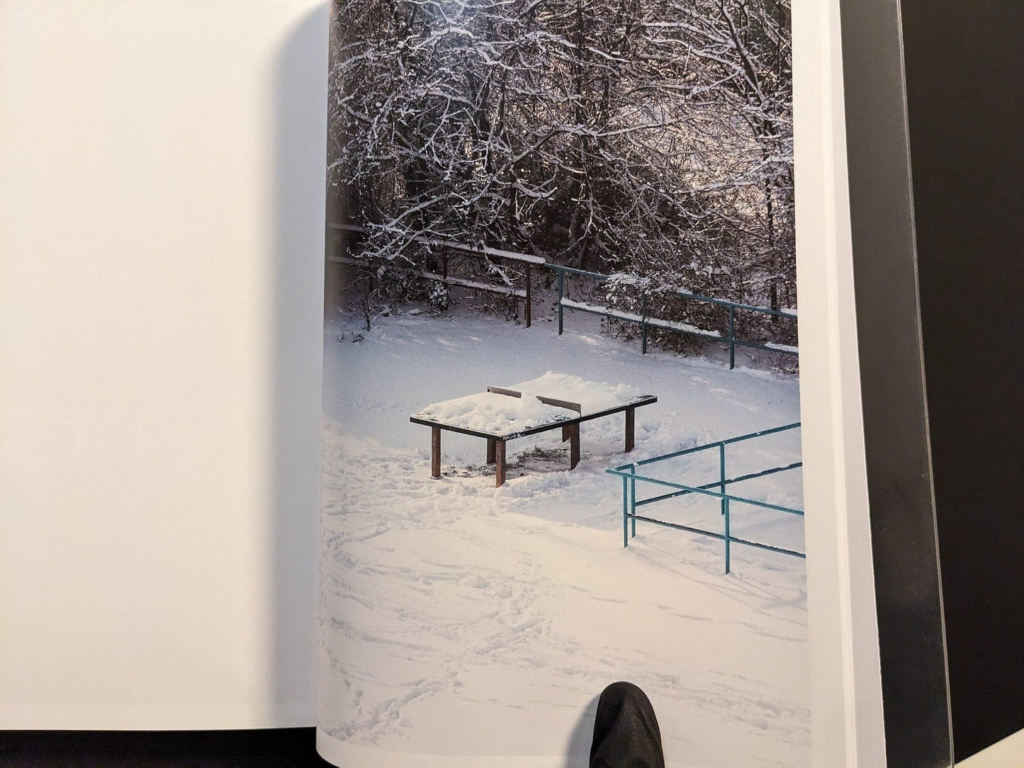 Photograph from TTP by Hayahisa Tomiyasu showing the table covered in snow during winter.