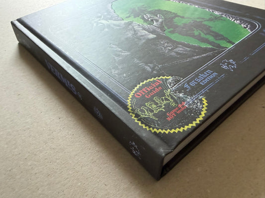 Angled view of the embossed hardcover, showing the raised cover art and the yellow-edged Forsaken Edition badge near the lower corner.