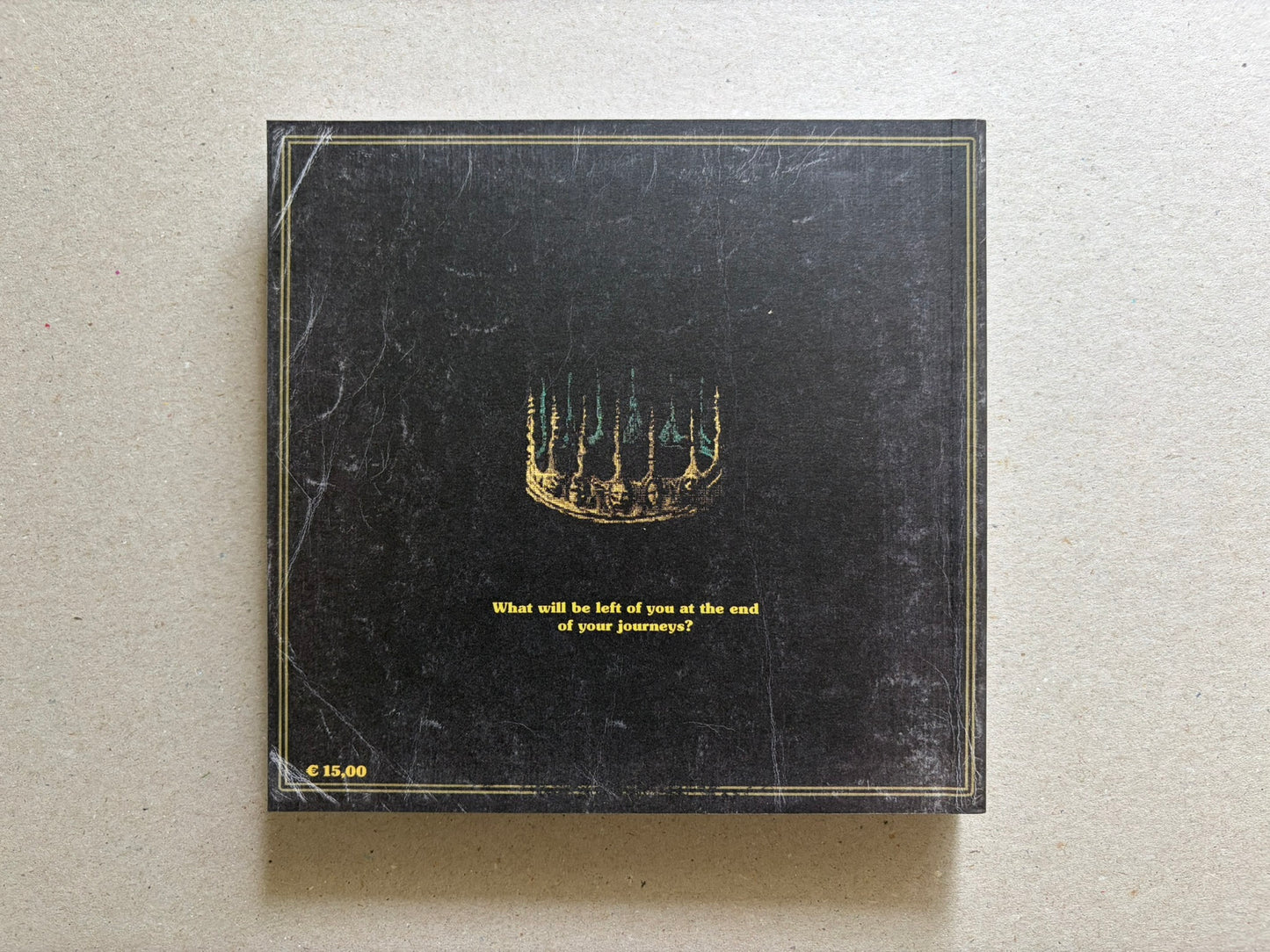 Vermis III back cover on a light tabletop, showing the black rear cover with the centered question and price mark.