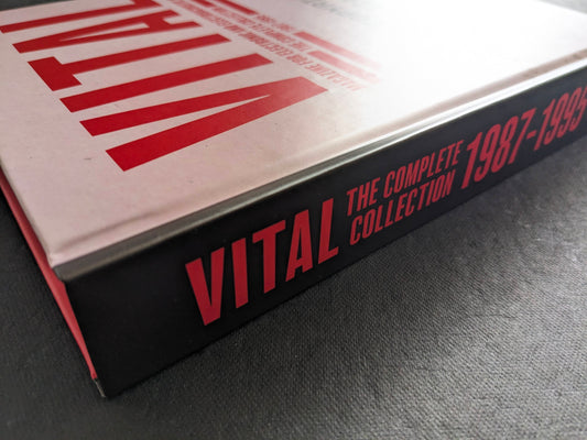Close-up of the black spine of Vital – The Complete Collection 1987-1995 with red title text