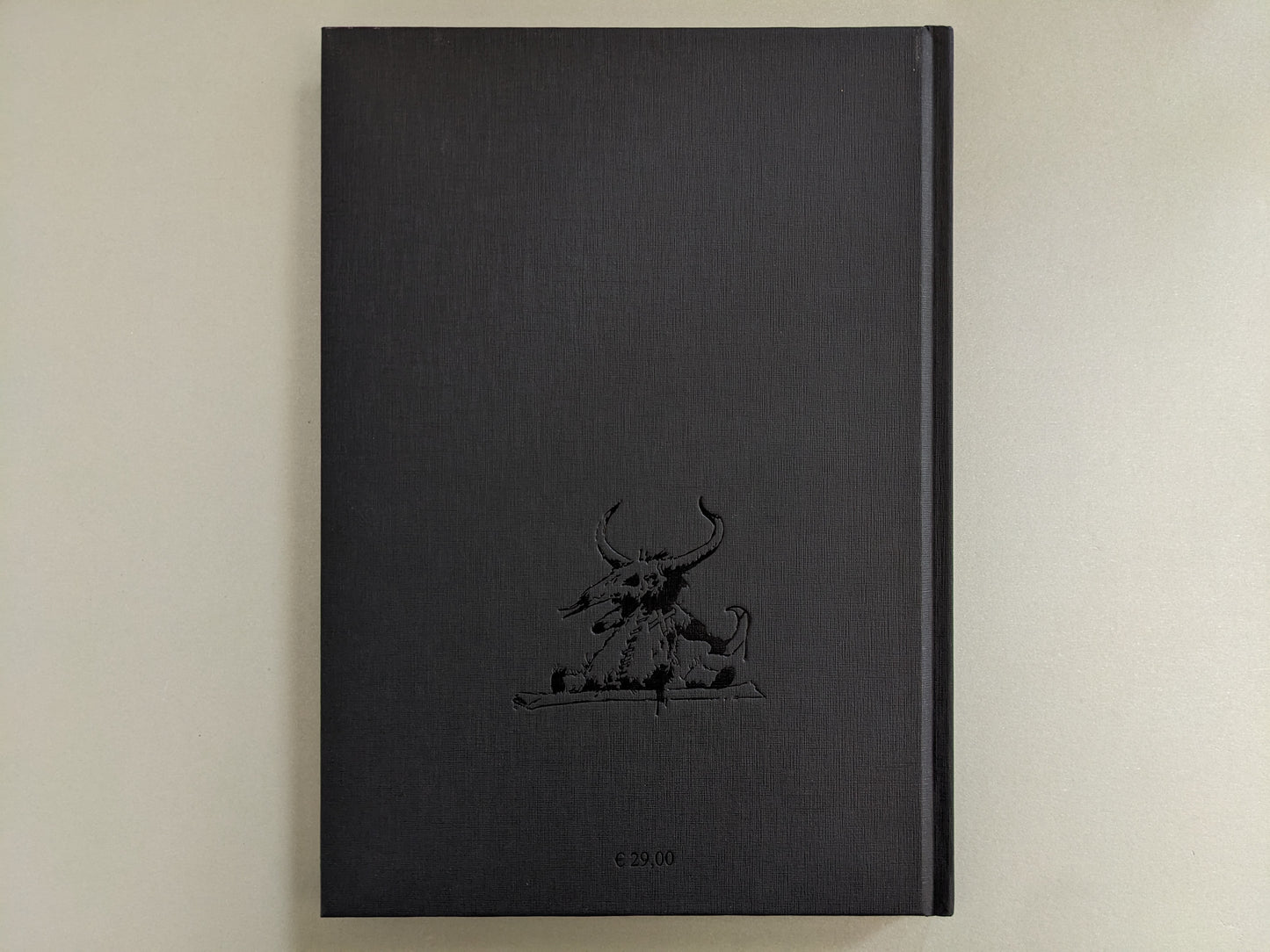 Back cover of 'Voodoo Forest' by John Blanche, showing a black clothbound texture with embossed demonic creature