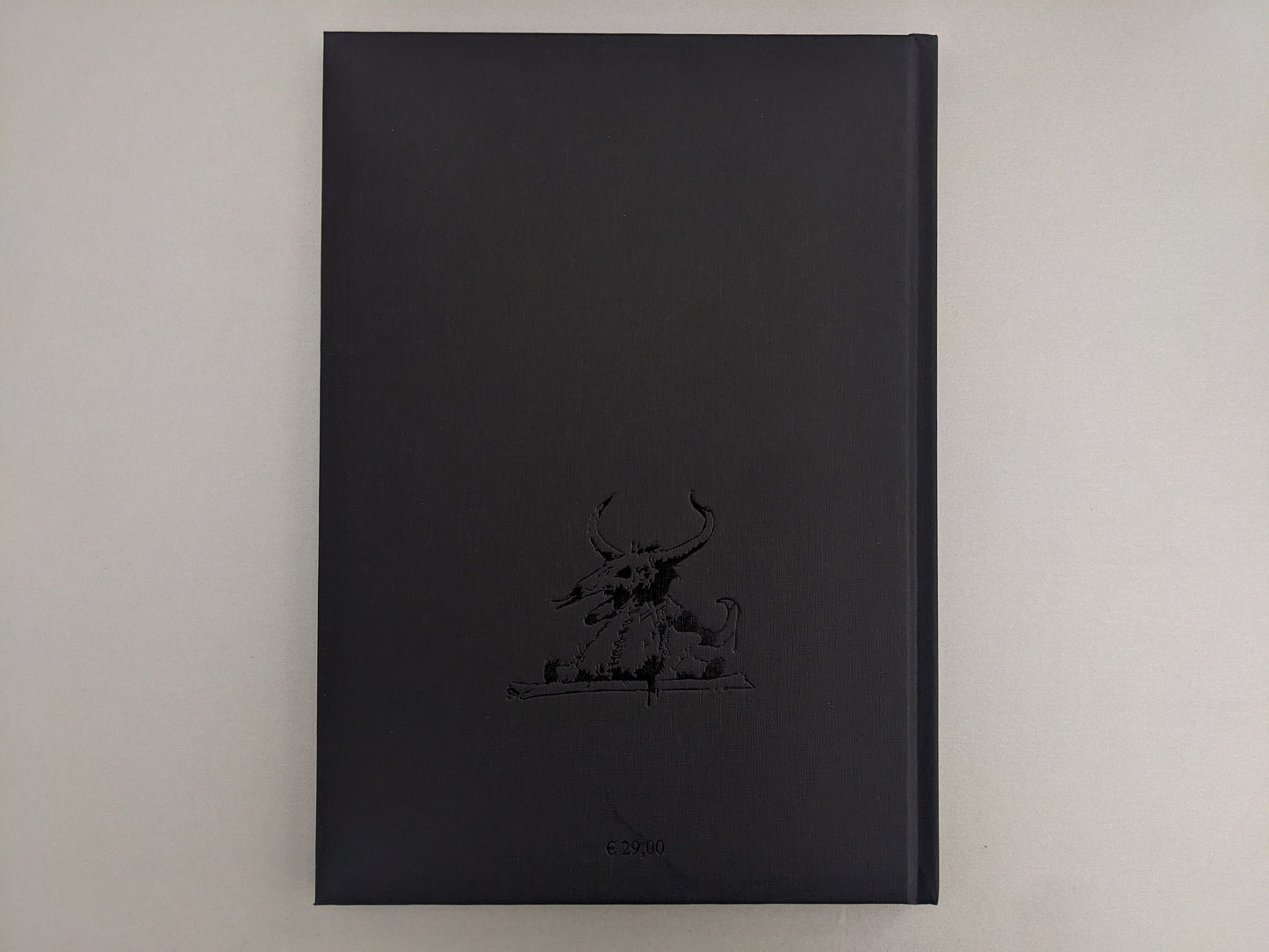 Back cover of 'Voodoo Forest' by John Blanche, showing a black clothbound texture with embossed demonic creature