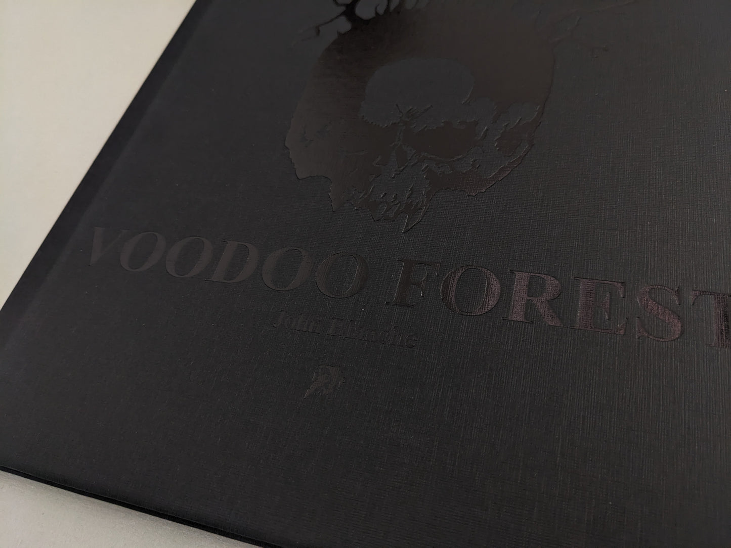Front cover closeup of 'Voodoo Forest' by John Blanche with embossed skull and tree roots