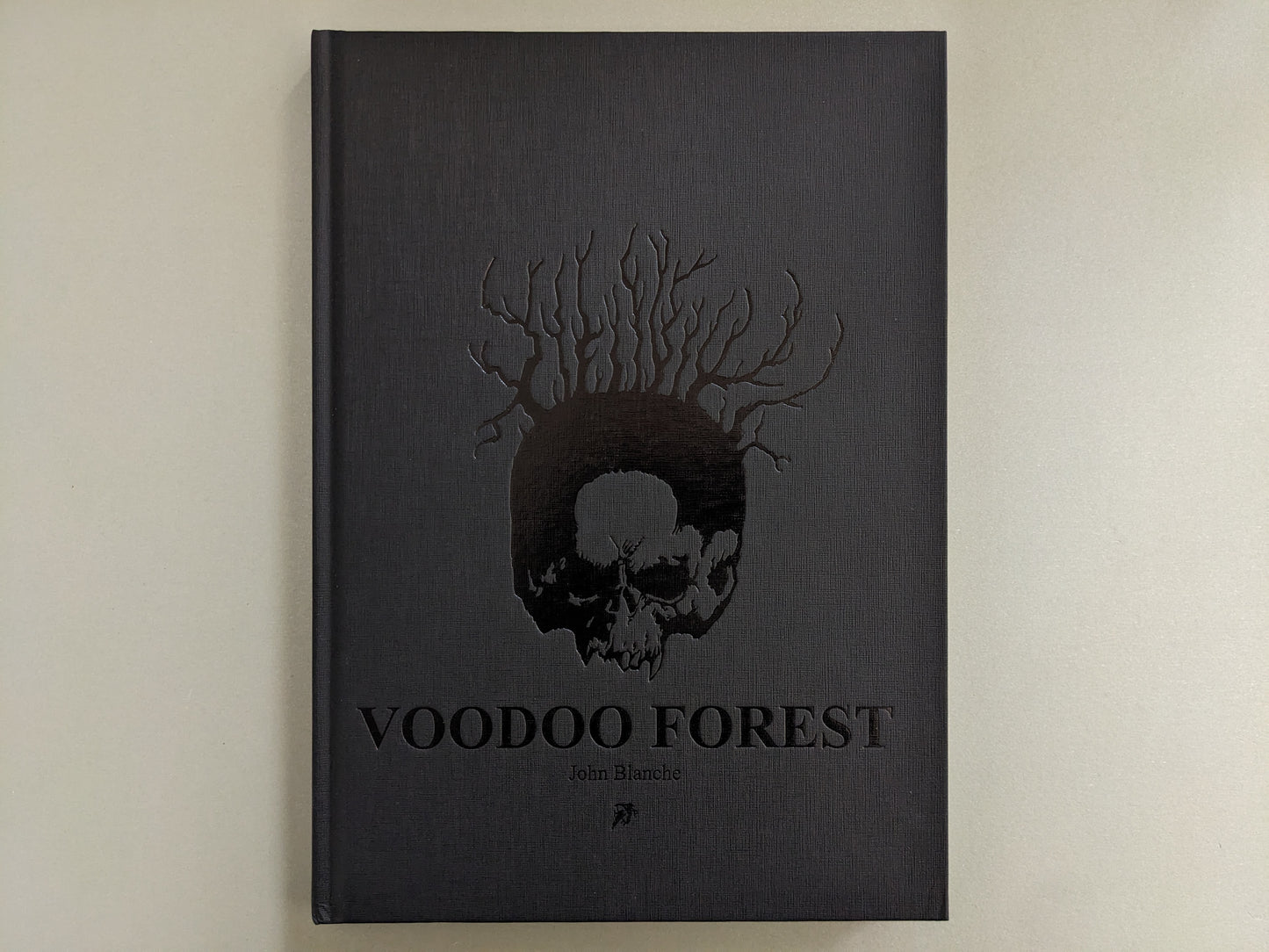 Front cover of 'Voodoo Forest' by John Blanche with embossed skull and tree roots