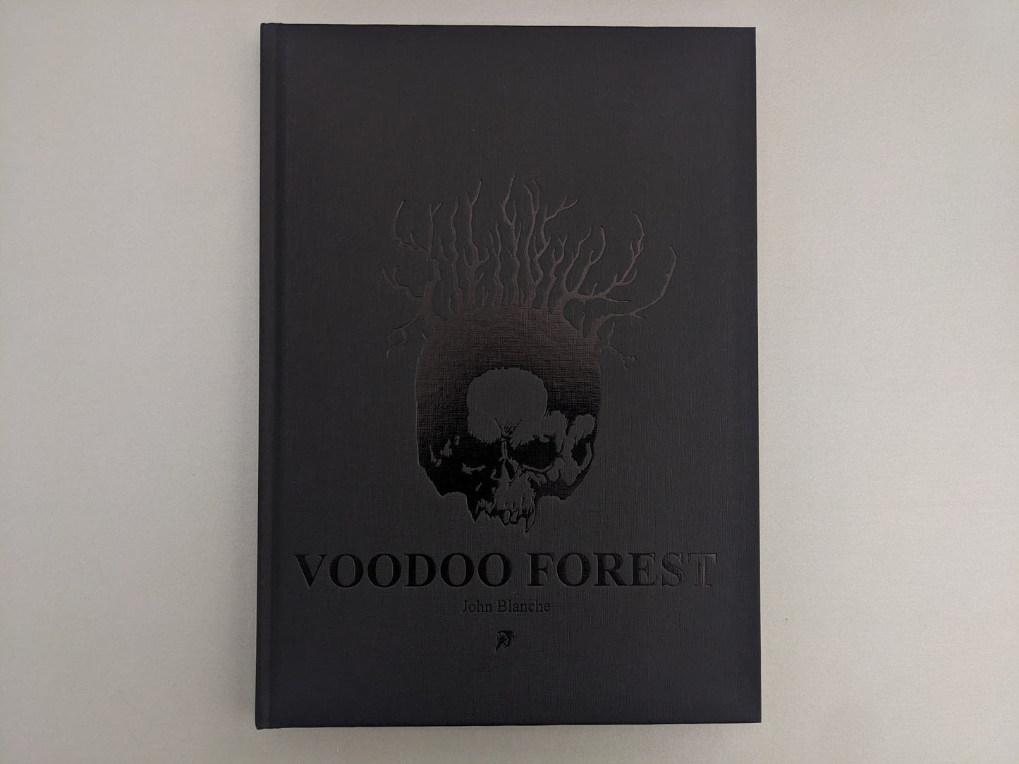 Front cover of 'Voodoo Forest' by John Blanche with embossed skull and tree roots