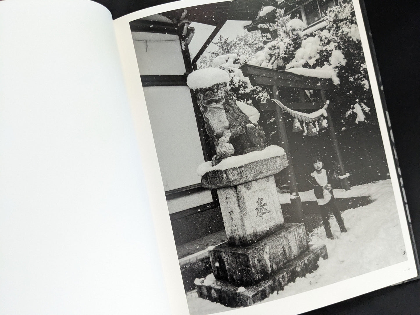 Snow-covered shrine with child in winter from Wandering Dog by Mai Nakama
