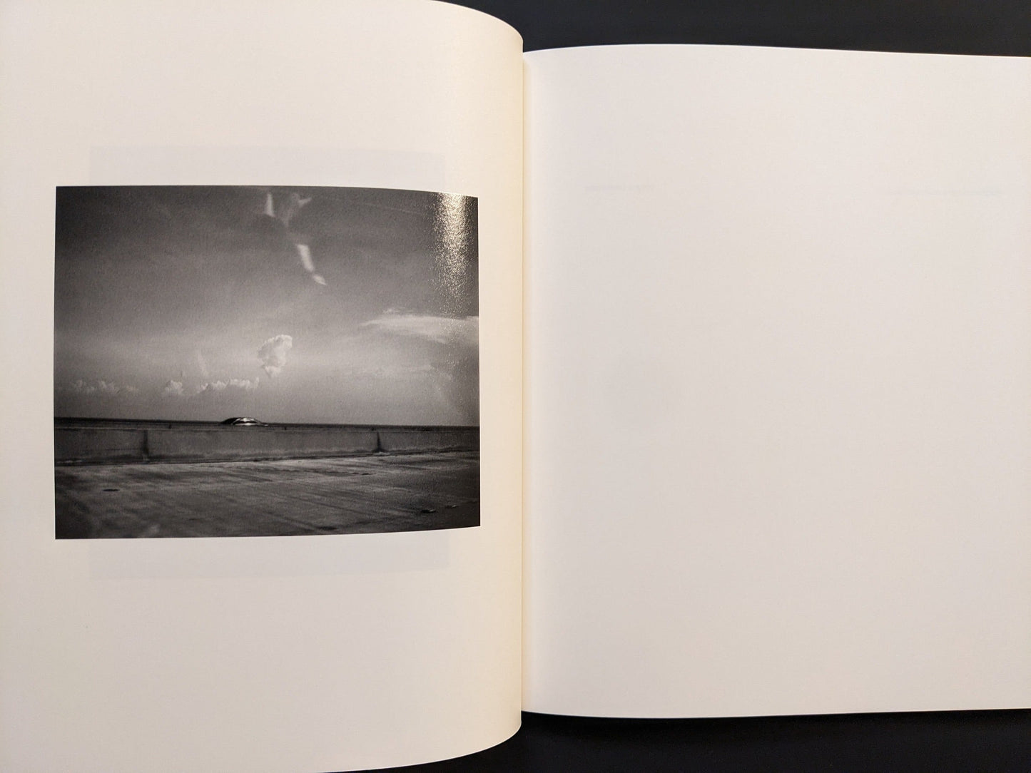 Page view featuring a minimalist black-and-white photograph from i shall sing these songs beautifully by Yorgos Lanthimos.