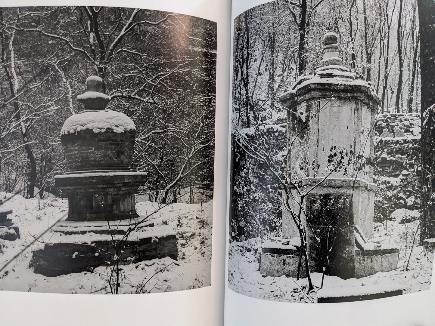 Spread from The Ancient Towers featuring images of stone towers partially covered in snow.