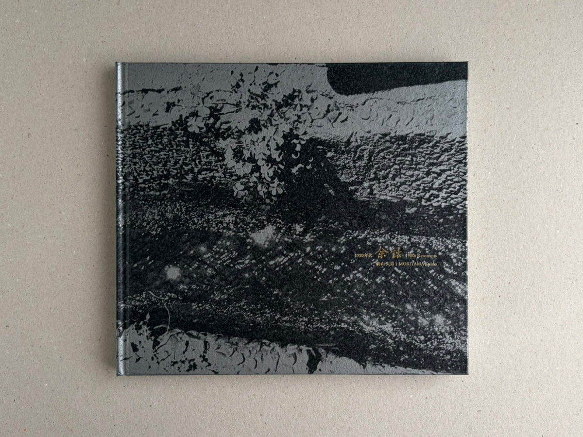 Front cover of 1980s Remnants by Daido Moriyama, hardcover book with a black-and-white abstract image and gold title text.