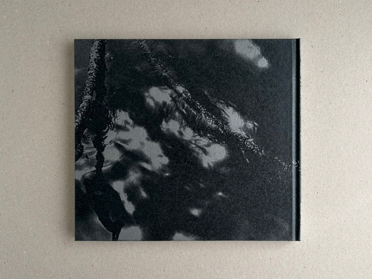 Front cover of 1980s Remnants by Daido Moriyama, showing a black-and-white abstract photograph on a hardcover book.