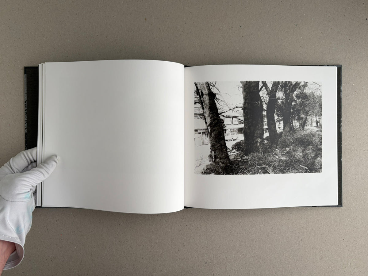 Open copy of 1980s Remnants — Daido Moriyama showing a blank left page and a black-and-white photograph on the right page.