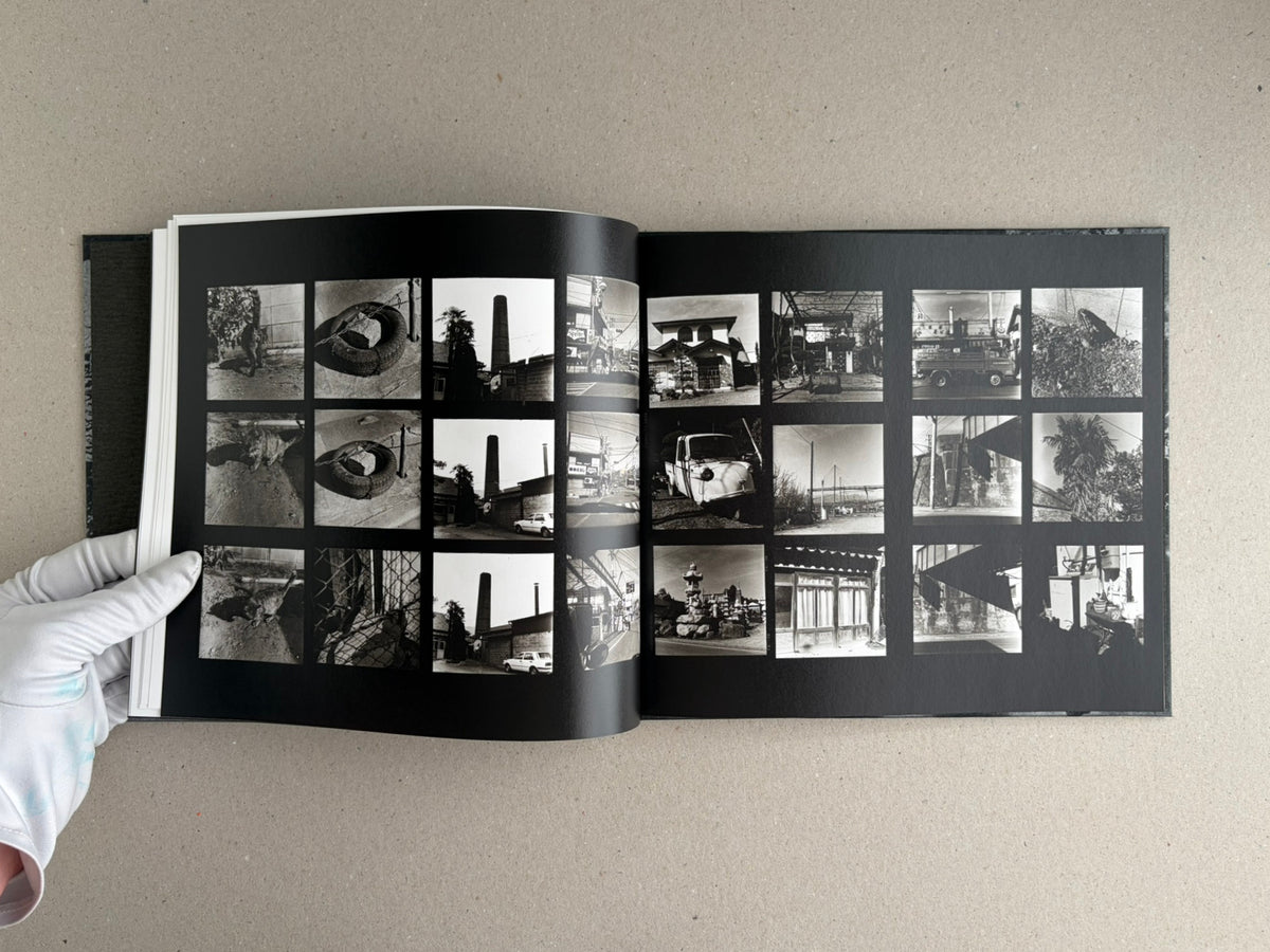 Open spread from 1980s Remnants by Daido Moriyama, showing a grid of small black-and-white photographs on black pages.