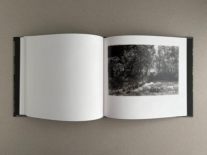 Open spread of 1980s Remnants by Daido Moriyama, showing a black-and-white landscape photograph on the right-hand page and a blank left-hand page.
