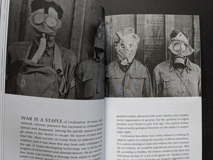 Spread from A People’s History of Civilization – historical photograph of soldiers in gas masks with essay on war and civilization