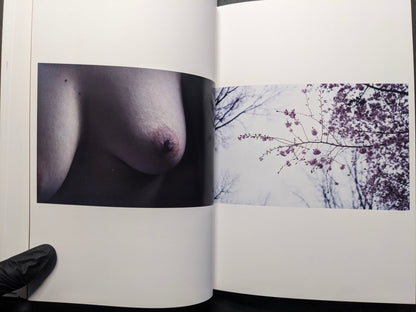 Interior spread juxtaposing a bare body close-up and cherry blossom branches.