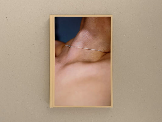 A Season Particular — Shen Wei, front cover showing a close-up of skin and a thin chain necklace on a beige casebound book.