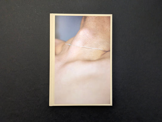 Front cover of A Season Particular by Shen Wei, a close-up photograph of a neck and shoulder with a necklace.
