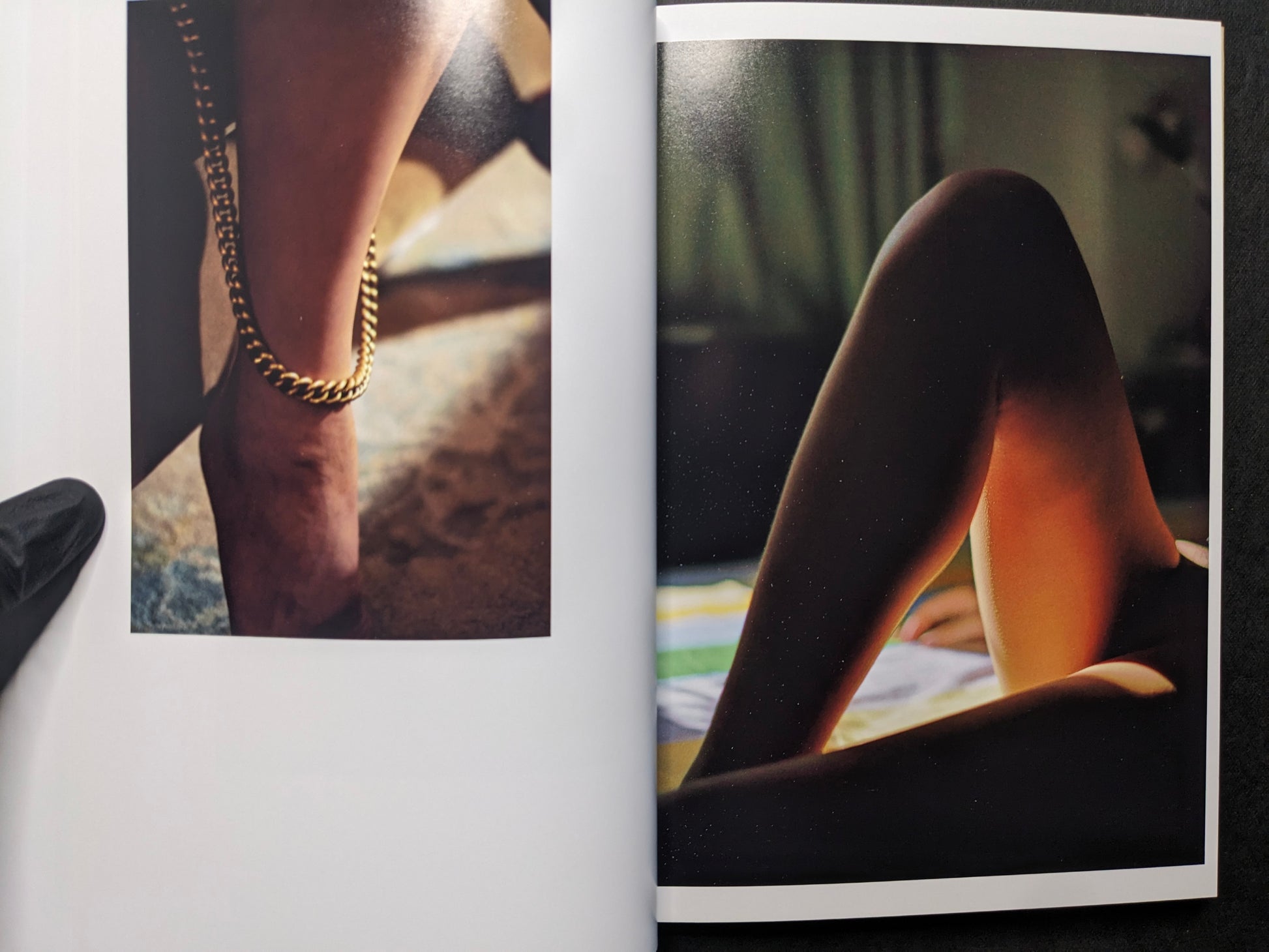 Interior spread showing a close-up of a leg with a chain anklet and a photograph of legs in dark stockings.