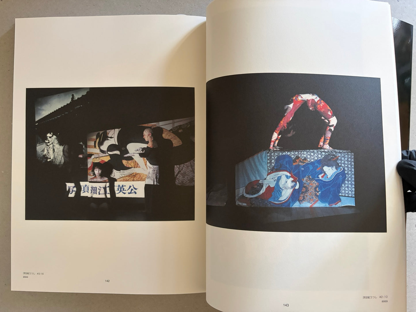 Two-page spread with Japanese text pages, photographed at an angle under warm light.