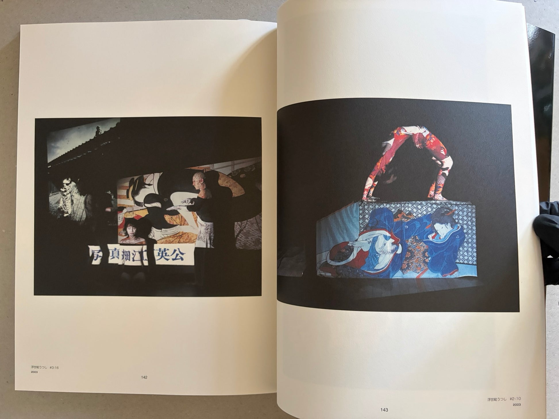 Two-page spread with Japanese text pages, photographed at an angle under warm light.