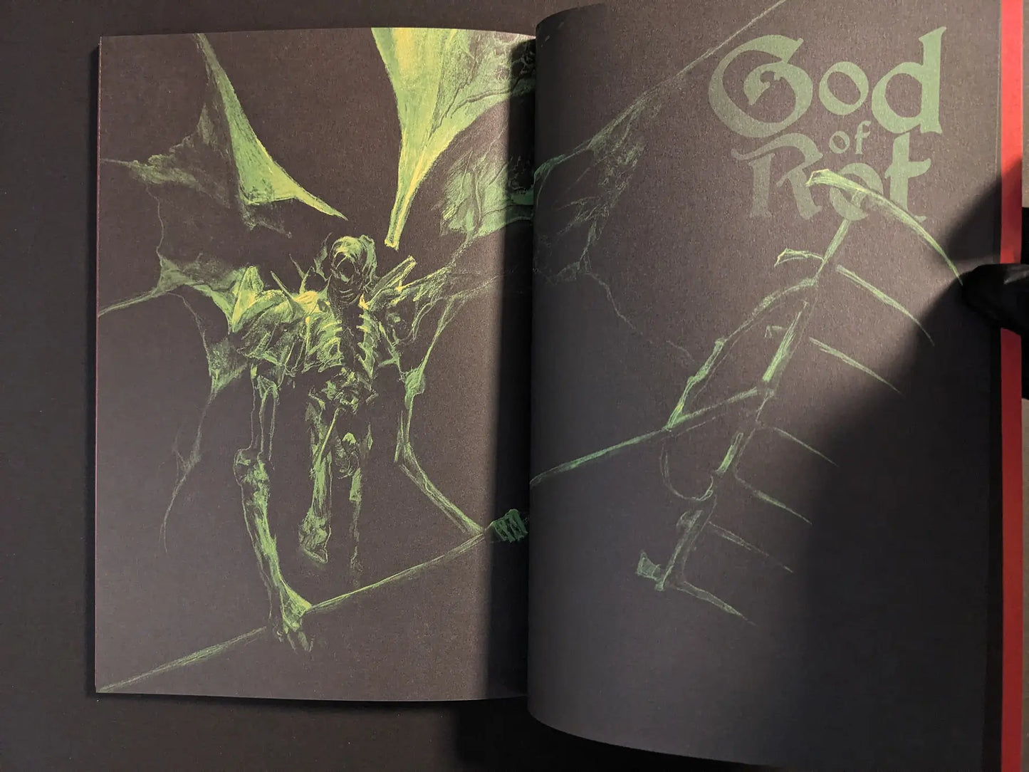 Double-page illustration of the winged skeletal God of Rot figure on a dark background.