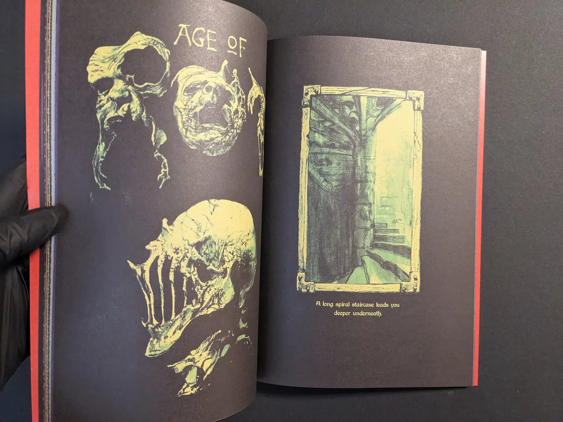 Interior spread with green skull designs on a black background and a spiral dungeon staircase drawing.