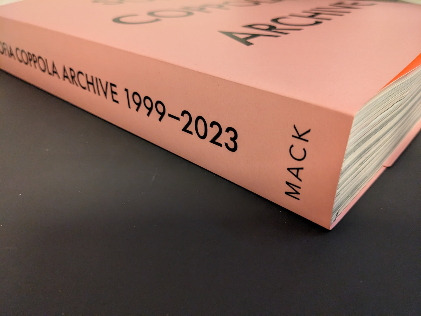 Book spine of Sofia Coppola: Archive 1999–2023 published by MACK, showing pink cover with black typography
