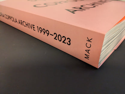 Book spine of Sofia Coppola: Archive 1999–2023 published by MACK, showing pink cover with black typography