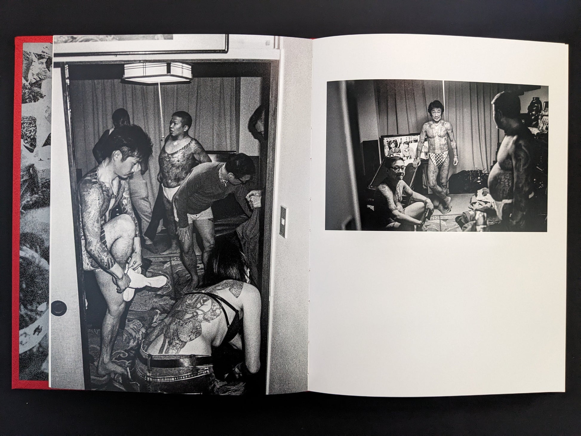 Group of tattooed men and women in a low-lit interior