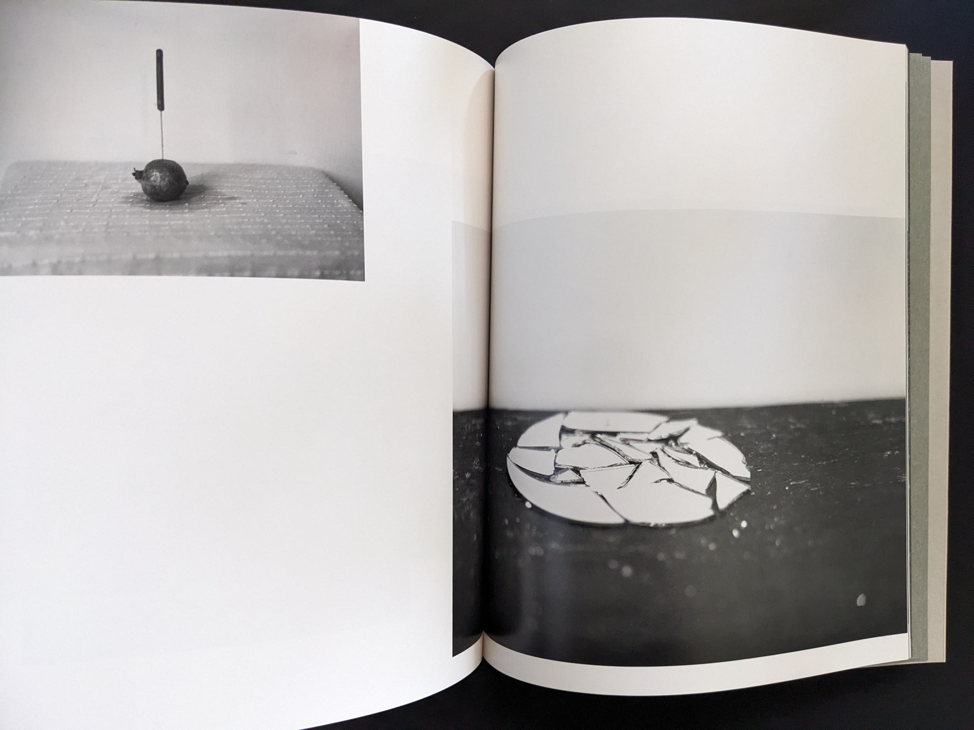 Double-page spread from Ash (New Edition) by Muge, knife in fruit and broken ceramic plate composition.