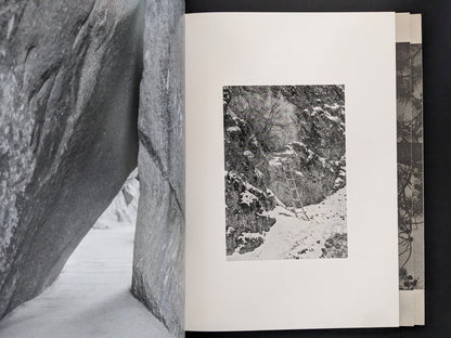 Open spread from ASH (New Edition) by Muge, with a snowy forest landscape on the right page.