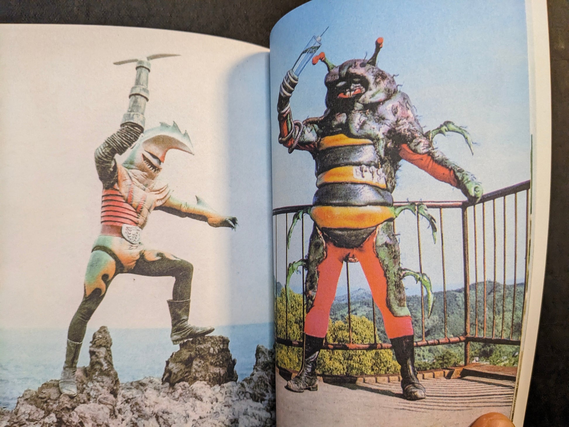 Interior spread from Bad People showing two elaborate Japanese TV series villain costumes posed against sky and landscape.