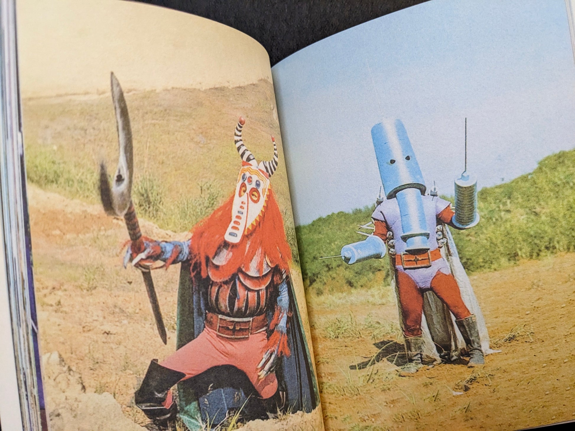 Interior spread from Bad People with two masked Japanese TV series villains posed with spears outdoors.