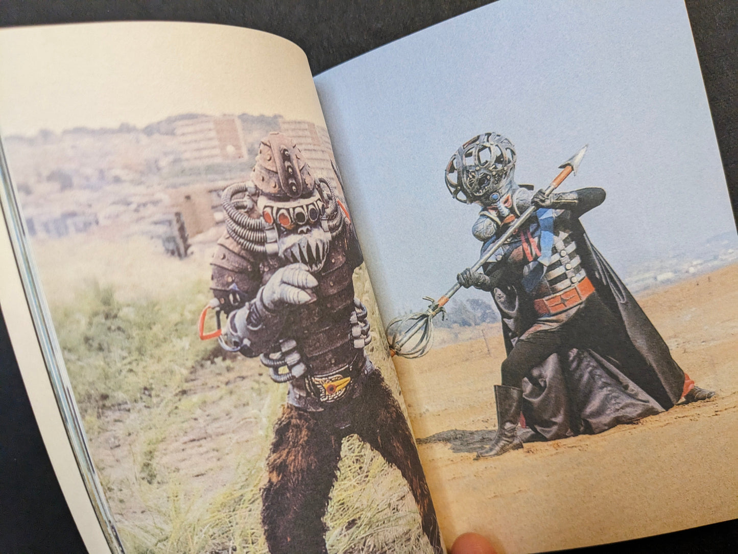 Interior spread from Bad People showing two Japanese TV series villain costumes posed in a rocky outdoor landscape.