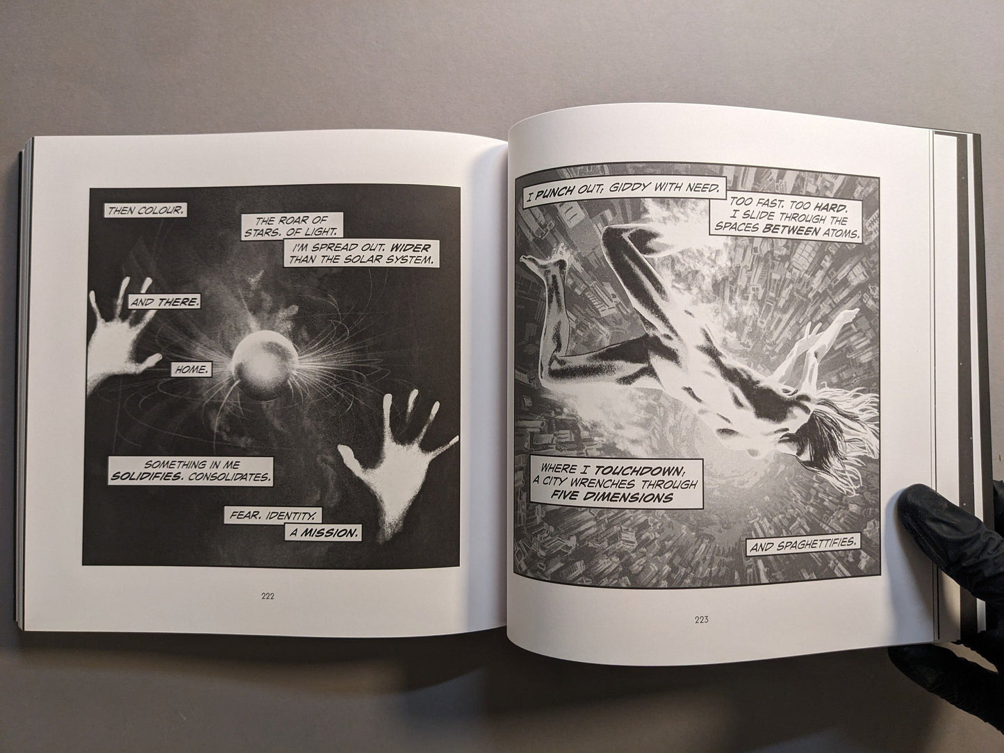 Interior spread: nude figure falling through a cityscape and hands reaching toward a glowing sphere; surreal sci-fi sequence.