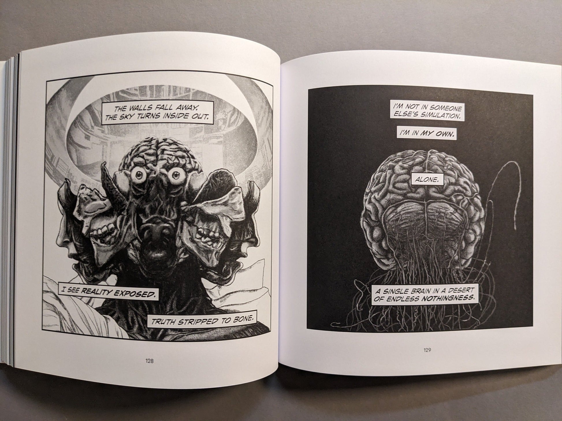 Interior spread with a suspended brain and a grotesque multi-faced head in surreal monochrome.