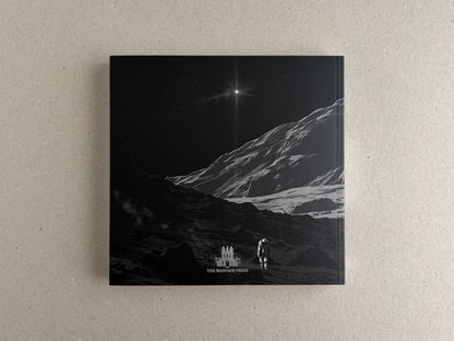 Back cover with an astronaut on a rocky slope and a starburst in the distance.