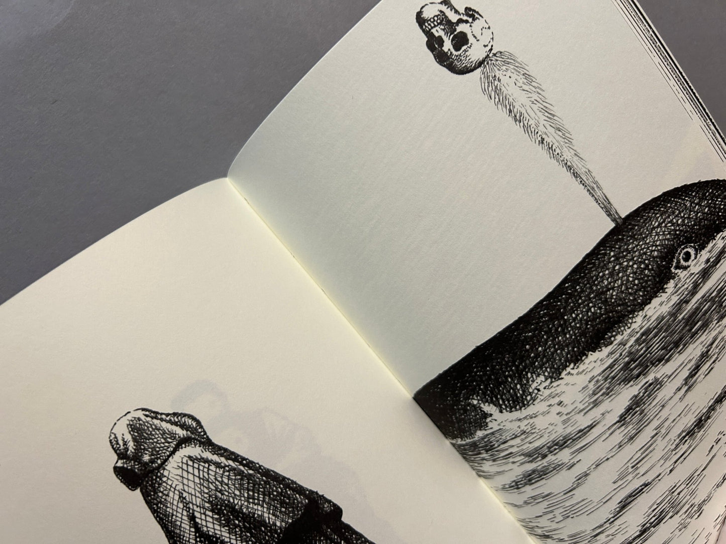 Bal de tête interior spread with surreal black line drawings on cream pages