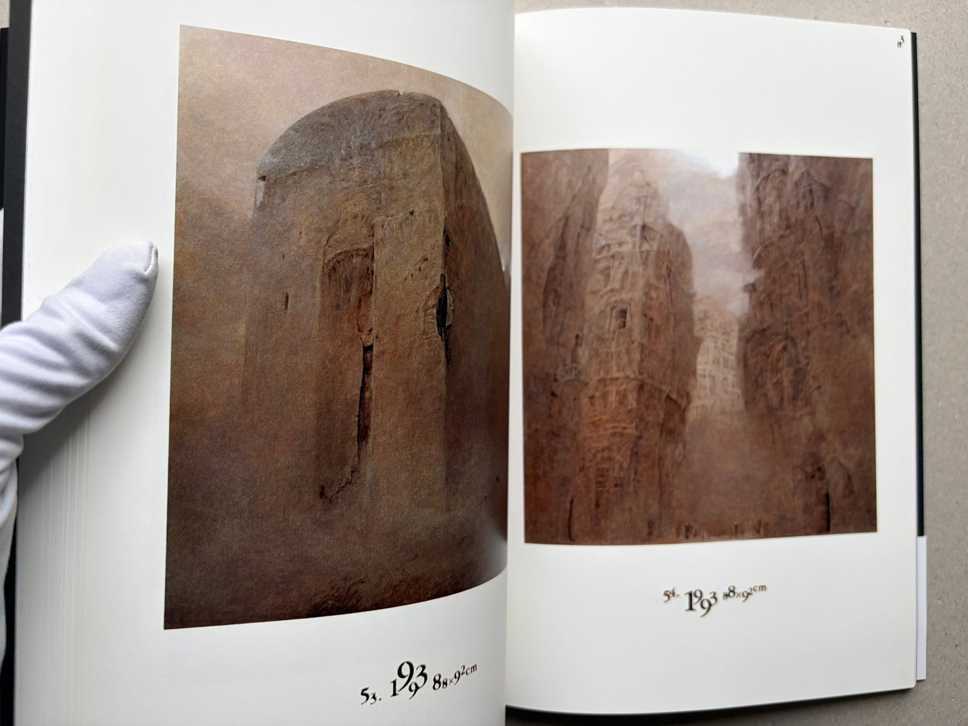 Interior spread from Beksinski 1929-2005 with two brown-toned reproductions on facing pages.