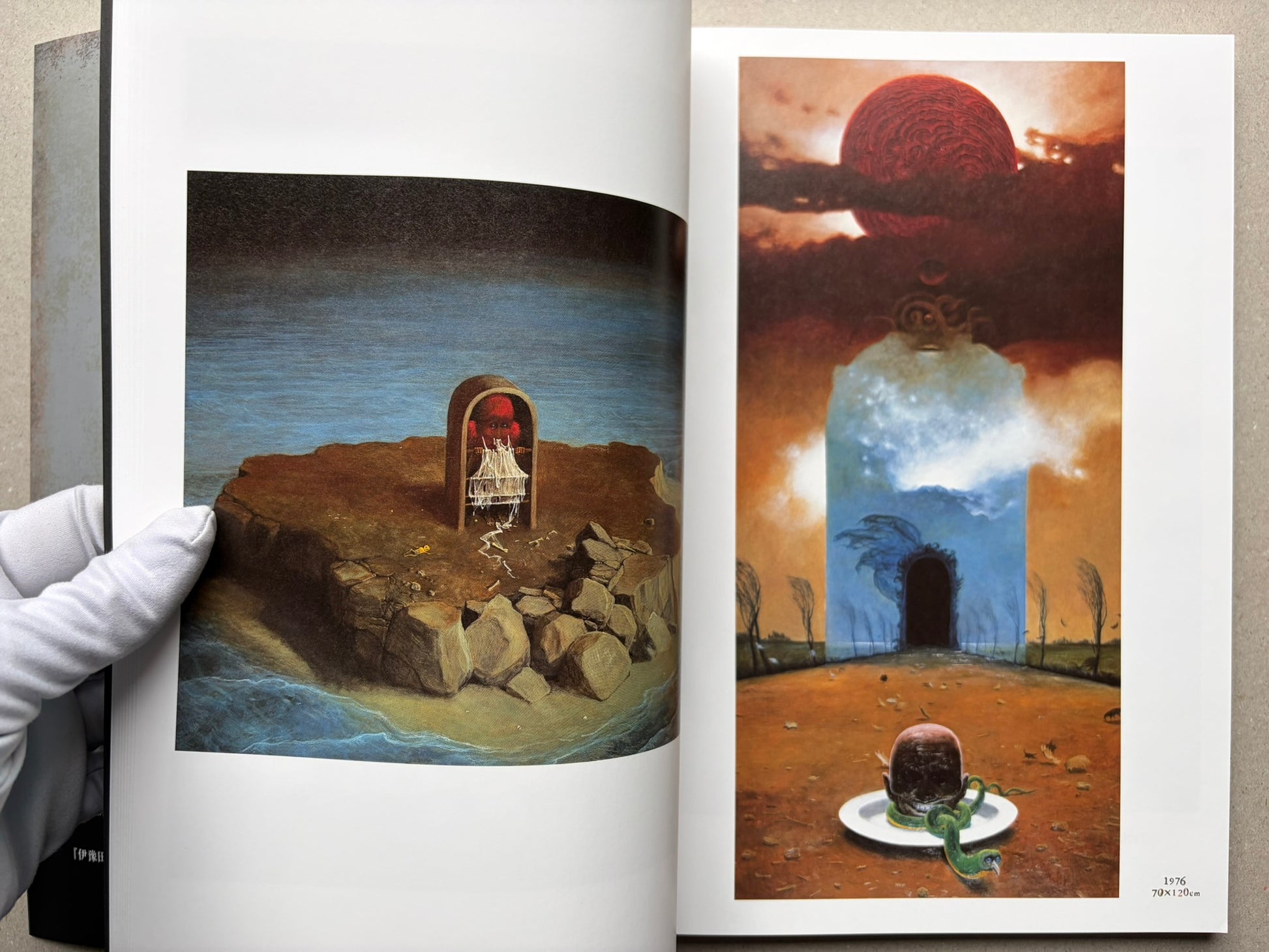 Open spread from Beksinski - The Collected Works I ver. 1.2 with a tall orange painting on the right page and a smaller landscape painting on the left.