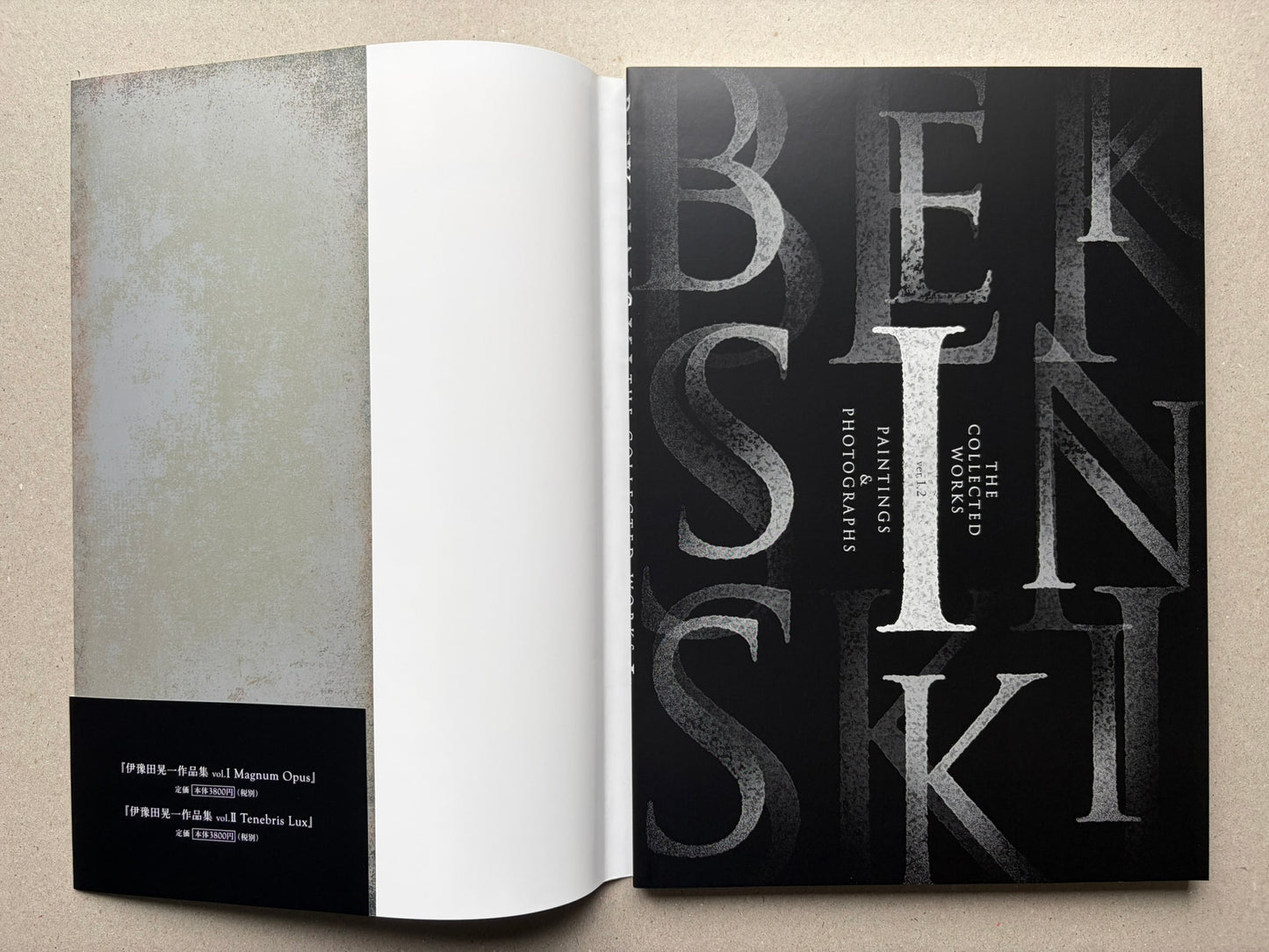 Open Beksinski book showing a title spread, with a blank left page and a black title page on the right.