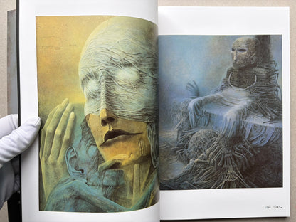 Open spread from Beksinski - The Collected Works I ver. 1.2 with two colour paintings of masked or veiled figures.