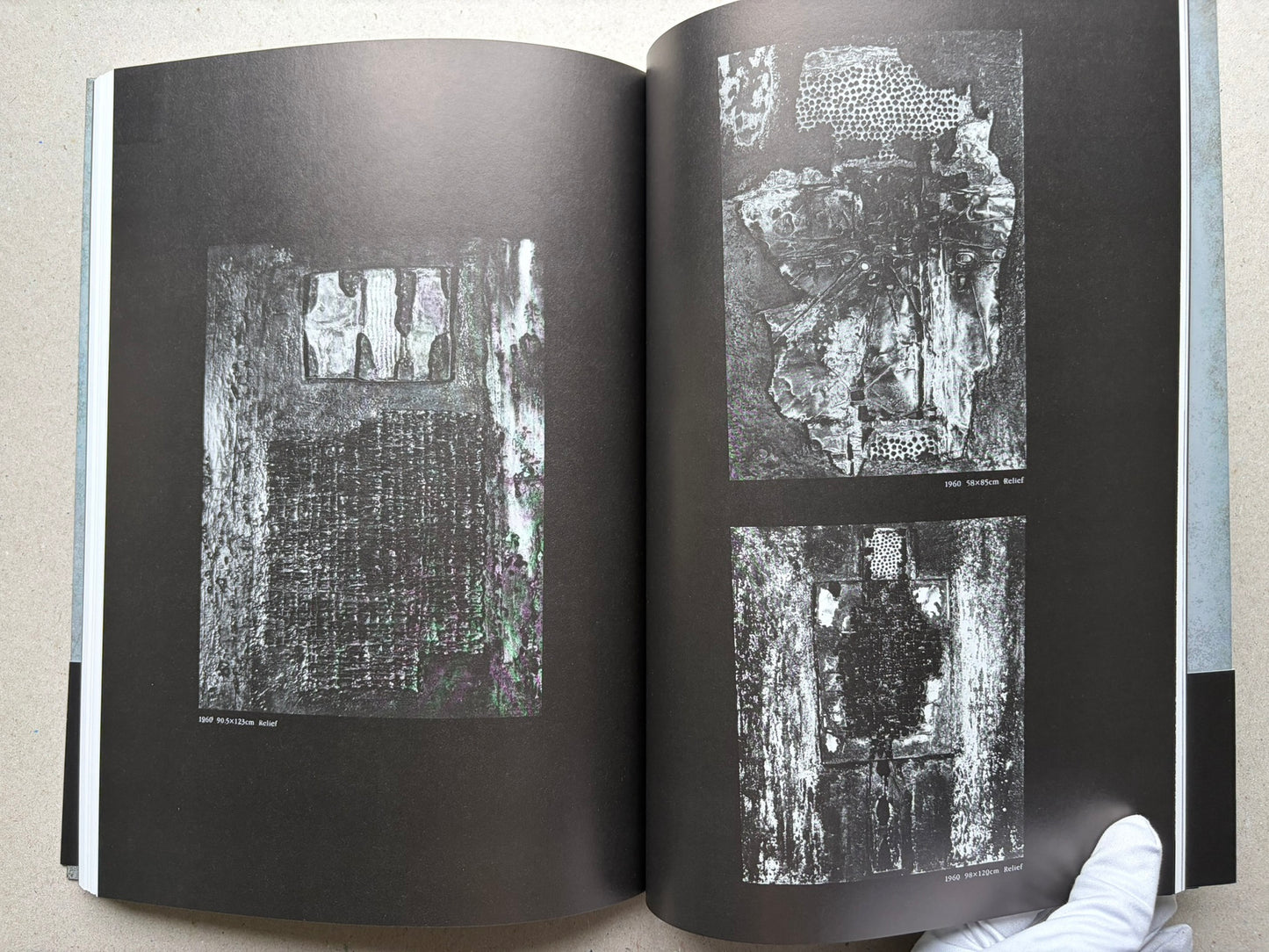 Beksiński: The Collected Works II ver. 1.2 open to black pages with relief images.