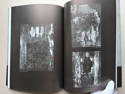 Beksiński: The Collected Works II ver. 1.2 open to black pages with relief images.