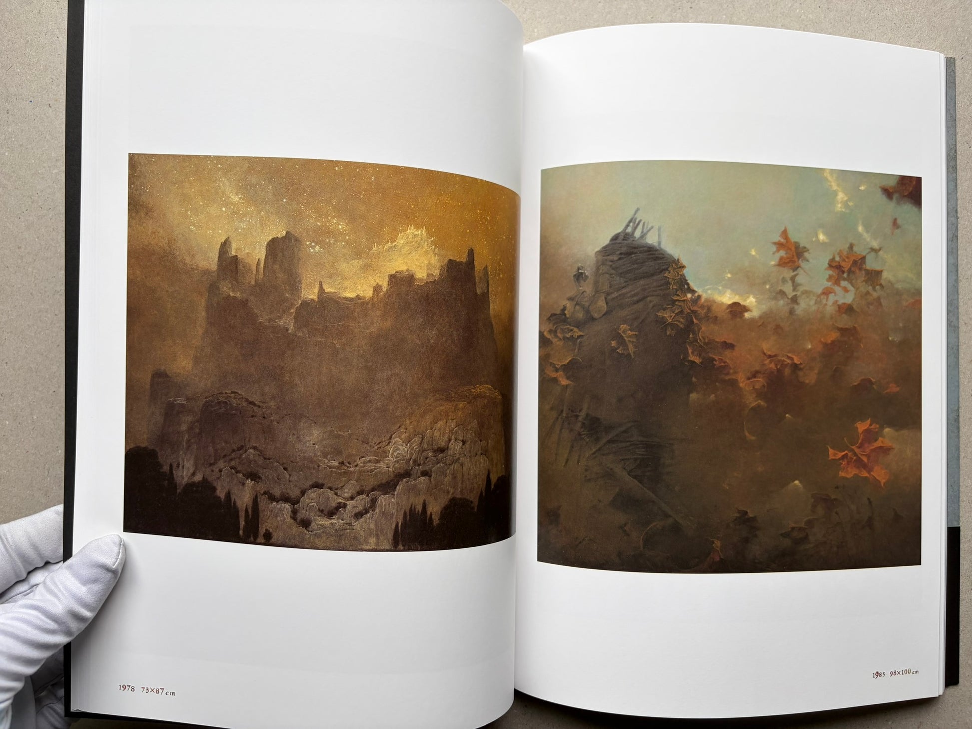 Beksiński: The Collected Works II ver. 1.2 open to two landscape paintings.