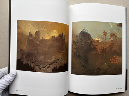 Beksiński: The Collected Works II ver. 1.2 open to two landscape paintings.