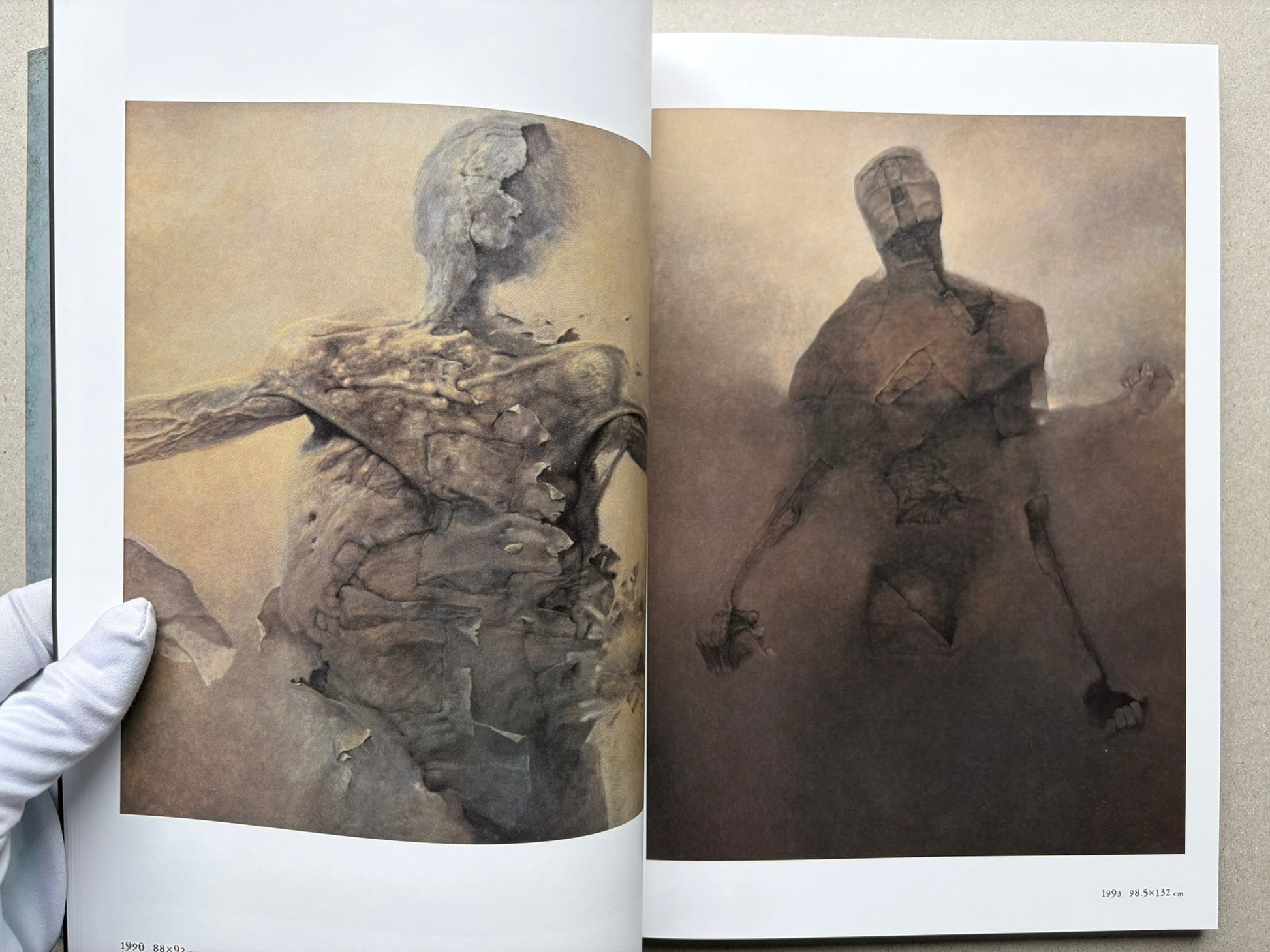 Beksiński: The Collected Works II ver. 1.2 open to two paintings across a spread.