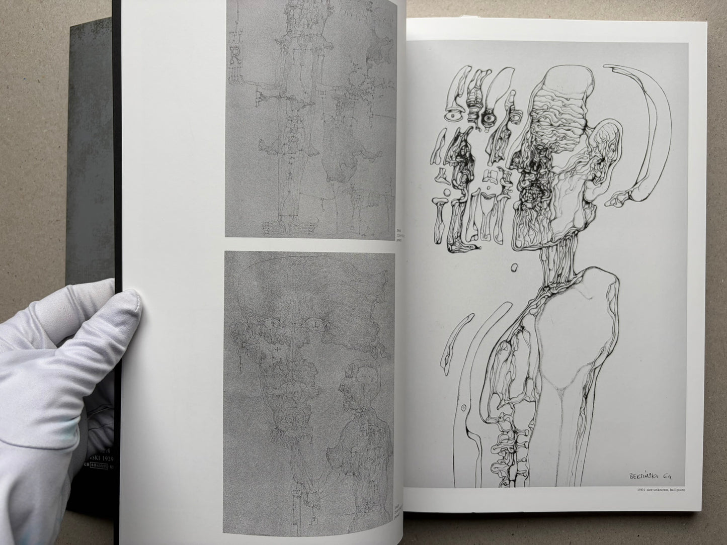Open spread of Beksinski - The Collected Works III ver. 1.2, showing two black-and-white drawing reproductions and a gloved hand holding the page.